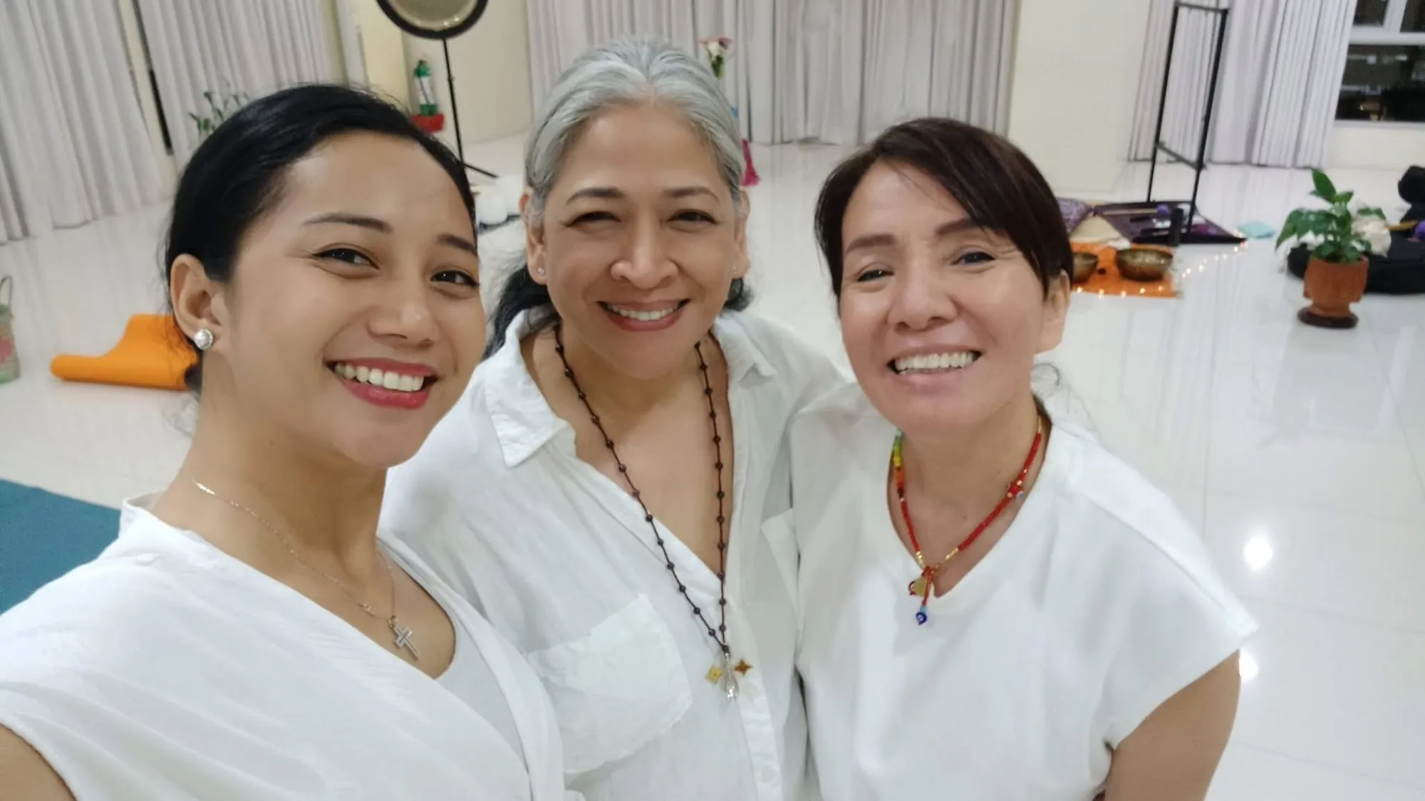 Group yoga practice in a white studio