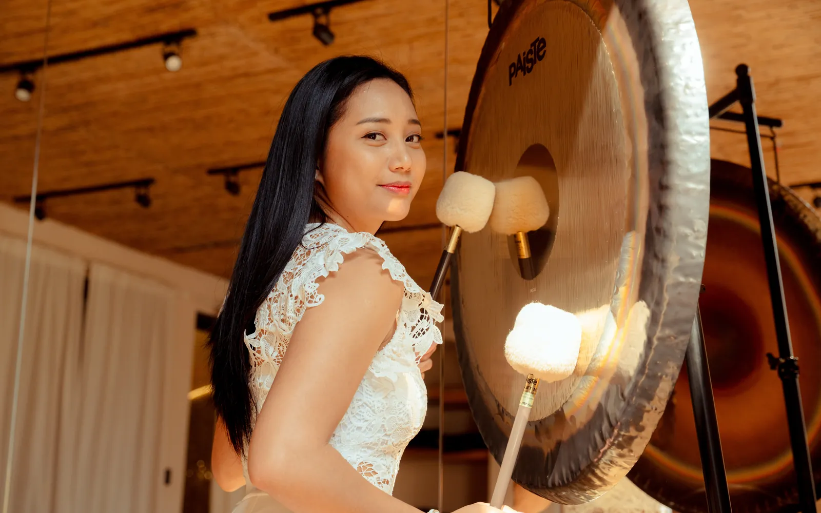 Alona Tera playing a gong in the studio