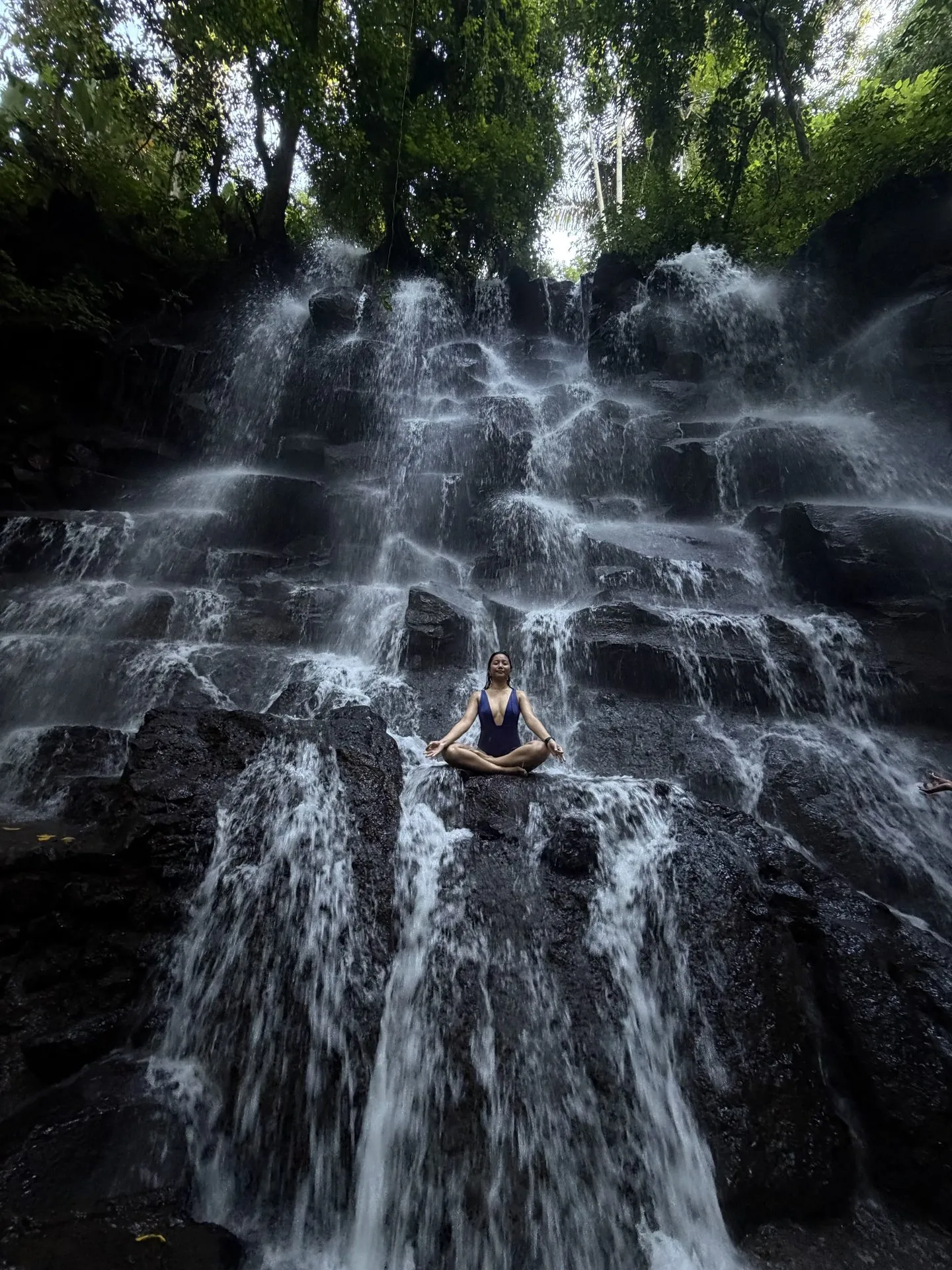 Meditation beside a waterfall in nature